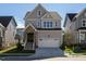 Two-story home with a neutral color scheme and two-car garage at 1719 Grassy Falls Ln, Wendell, NC 27591