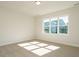 Well-lit bedroom with carpet and large window at 1719 Grassy Falls Ln, Wendell, NC 27591
