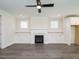 Open concept living room with fireplace and built-in shelving units at 1719 Grassy Falls Ln, Wendell, NC 27591