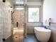 Luxurious bathroom with a soaking tub, walk-in shower, and modern fixtures at 1113 Destination Dr, Apex, NC 27523