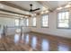 Spacious bonus room with hardwood floors, exposed beams, and a ceiling fan at 1113 Destination Dr, Apex, NC 27523