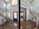 Two-story foyer with hardwood floors and staircase at 1113 Destination Dr, Apex, NC 27523