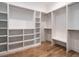 Large walk-in closet with custom built-in shelving and hanging rods at 1113 Destination Dr, Apex, NC 27523