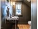 Dark-colored powder room with pedestal sink at 1113 Destination Dr, Apex, NC 27523