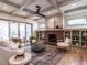 Spacious living room featuring a brick fireplace, built-in shelving, and hardwood floors at 1113 Destination Dr, Apex, NC 27523