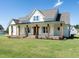 A farmhouse style home with a welcoming front porch at 1008 Azalea Garden Circle, Raleigh, NC 27603