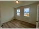 Bright bedroom with hardwood floors and two windows at 260 Chestnut Oak Ln, Lillington, NC 27546