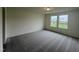 Bright bedroom with gray carpet and two windows at 260 Chestnut Oak Ln, Lillington, NC 27546