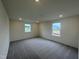 Spacious bedroom with gray carpet and two windows at 260 Chestnut Oak Ln, Lillington, NC 27546