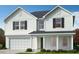 Two-story white house with gray roof and shutters at 260 Chestnut Oak Ln, Lillington, NC 27546