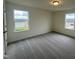 Bright bedroom with two windows and grey carpet at 260 Chestnut Oak Ln, Lillington, NC 27546