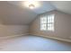 Bedroom with sloped ceiling and single window at 4800 Latimer Rd, Raleigh, NC 27609