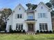 Two-story white farmhouse with shutters and a welcoming porch at 4800 Latimer Rd, Raleigh, NC 27609