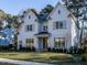 Two-story white farmhouse with a charming front porch and landscaping at 4800 Latimer Rd, Raleigh, NC 27609