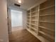 Built-in shelves line this hallway, leading to additional rooms at 4800 Latimer Rd, Raleigh, NC 27609