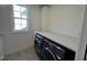 Bright laundry room features modern washer and dryer, ample counter space, and a window at 4800 Latimer Rd, Raleigh, NC 27609