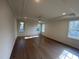 Large main bedroom with hardwood floors and multiple windows at 4800 Latimer Rd, Raleigh, NC 27609