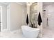 Spa-like bathroom with freestanding tub, walk-in shower, and marble tile at 40 Harvest View Way, Franklinton, NC 27525