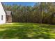 Large backyard with grassy area and tree line at 40 Harvest View Way, Franklinton, NC 27525