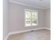 Bright bedroom with hardwood floors and a large window at 40 Harvest View Way, Franklinton, NC 27525