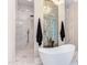 Bathroom features a soaking tub, walk-in shower, and marble tile at 40 Harvest View Way, Franklinton, NC 27525