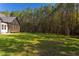 Spacious backyard with grassy area and tree line at 40 Harvest View Way, Franklinton, NC 27525