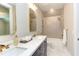 Modern bathroom with double vanity, herringbone tile shower, and white fixtures at 40 Harvest View Way, Franklinton, NC 27525
