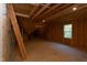 Unfinished bonus room with window and exposed beams at 40 Harvest View Way, Franklinton, NC 27525