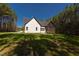 White house with screened porch and deck, nestled in a wooded area at 40 Harvest View Way, Franklinton, NC 27525