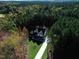 Aerial view of a house nestled in a wooded area at 40 Harvest View Way, Franklinton, NC 27525