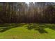 Wooded lot with grassy clearing, ready for new construction at 40 Harvest View Way, Franklinton, NC 27525