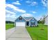 Newly constructed home with blue siding, two car garage, and well-manicured lawn at 169 Liam Dr, Broadway, NC 27505