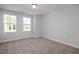 Well-lit bedroom featuring carpet flooring and windows at 69 Fairwinds Dr, Lillington, NC 27546