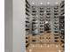 Modern glass-walled wine cellar showcasing an extensive collection at 1308 Hedgelawn Way, Raleigh, NC 27615