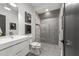 Modern bathroom with a white vanity, toilet and a large walk-in shower at 1308 Hedgelawn Way, Raleigh, NC 27615