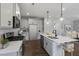 Modern kitchen with island, gray cabinets, and stainless steel appliances at 80 Plainfield Ln # Holly Georgian, Lillington, NC 27546