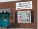 Attractive storefront of a coffee house with teal door and striped awning at 601 Sweet Potato Lane # 5, Nashville, NC 27856