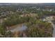 Aerial view of homes and pond in wooded area at 1329 Sanctuary Pond Dr, Raleigh, NC 27603