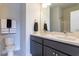 Modern bathroom with double vanity, gray cabinets, and a toilet at 213 Beacon Dr, Pittsboro, NC 27312