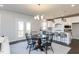 Charming dining area with a round table and four black chairs at 213 Beacon Dr, Pittsboro, NC 27312