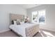 Spacious bedroom with a tufted headboard bed and large windows at 213 Beacon Dr, Pittsboro, NC 27312