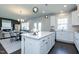 Well-appointed kitchen with white cabinets and a large island at 213 Beacon Dr, Pittsboro, NC 27312