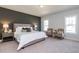 Spacious main bedroom with a plush bed and two accent chairs at 213 Beacon Dr, Pittsboro, NC 27312