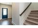 Stylish staircase with dark wood handrail and carpeted steps at 213 Beacon Dr, Pittsboro, NC 27312