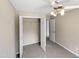 Spacious bedroom with ceiling fan, double-door closet, and neutral carpet at 4425 Woodlawn Dr, Raleigh, NC 27616