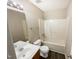 Clean bathroom with a single vanity, toilet, and tub shower combo at 4425 Woodlawn Dr, Raleigh, NC 27616