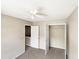 Well-lit bedroom with ceiling fan, double-door closet, and neutral carpeting at 4425 Woodlawn Dr, Raleigh, NC 27616