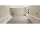 Bright dining area with large window, neutral carpeting, and chair railing at 4425 Woodlawn Dr, Raleigh, NC 27616