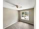 Spacious bedroom with ceiling fan, large window, and neutral carpeting at 4425 Woodlawn Dr, Raleigh, NC 27616