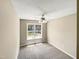 Charming bedroom with a window showcasing a neighborhood view and ceiling fan at 4425 Woodlawn Dr, Raleigh, NC 27616